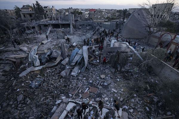 Palestinians look at a mosque destroyed in an Israeli strike in Rafah, Gaza Strip Wednesday. (Picture: AP Photo/Fatima Shbair)